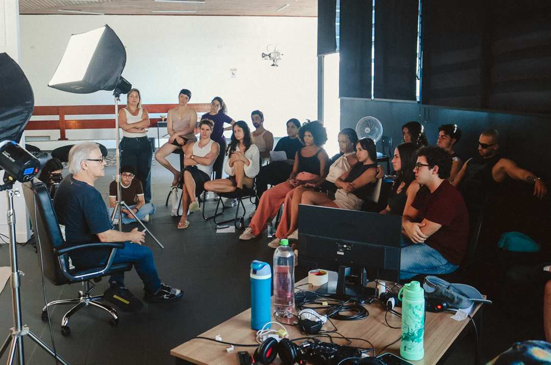 Diretor conduzindo workshop com turma cheia no estúdio